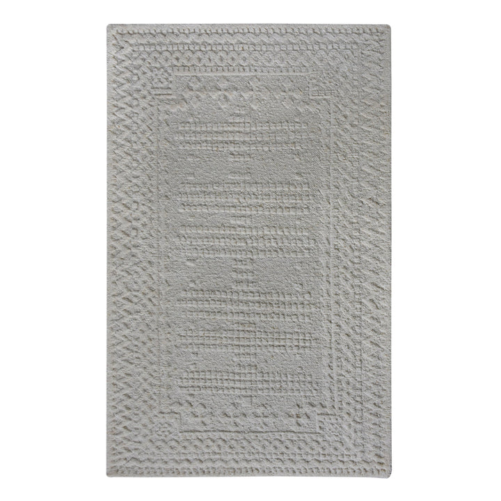 Chowk hand-knotted NZ wool rug in dove grey with a tone-on-tone raised grid and border, under a dining table