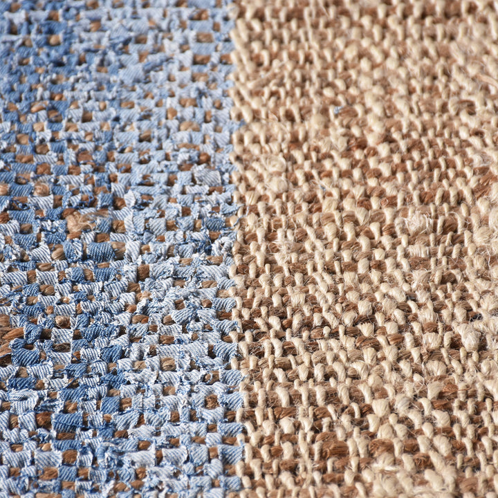 Nahar flatweave hemp and denim rug with a denim-blue stripe on natural hemp, in a living room