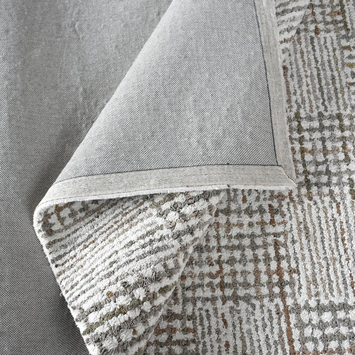 Tweed hand-tufted denim and cotton rug with fine grey and ivory check, in a bedroom