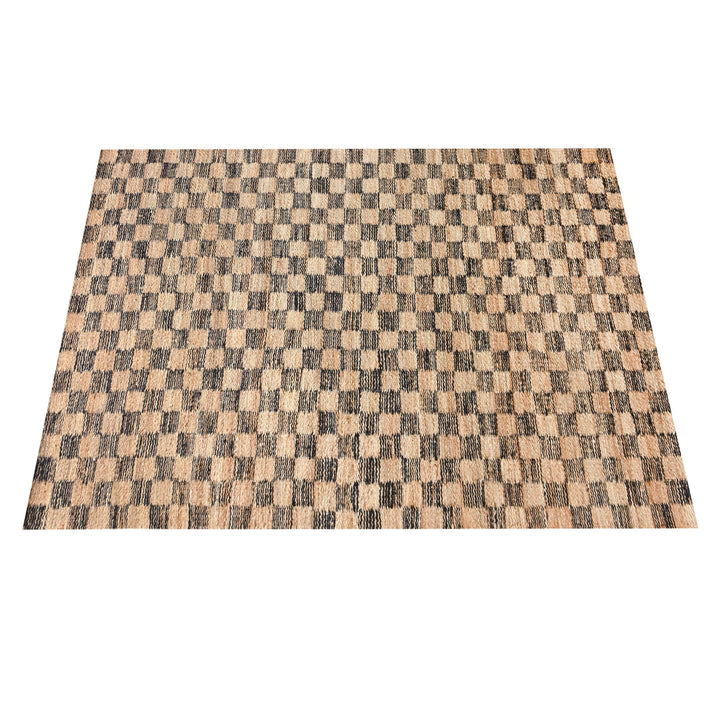 Chessboard handwoven jute rug with natural and charcoal checkerboard, in a living room