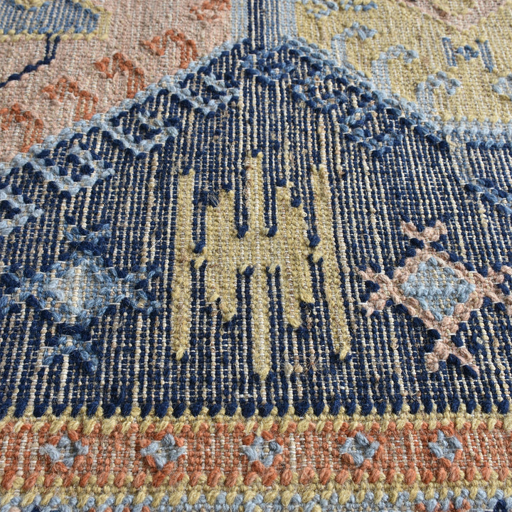 Harbour flatweave navy wool and hemp kilim rug with gold and rust medallions, in an entryway