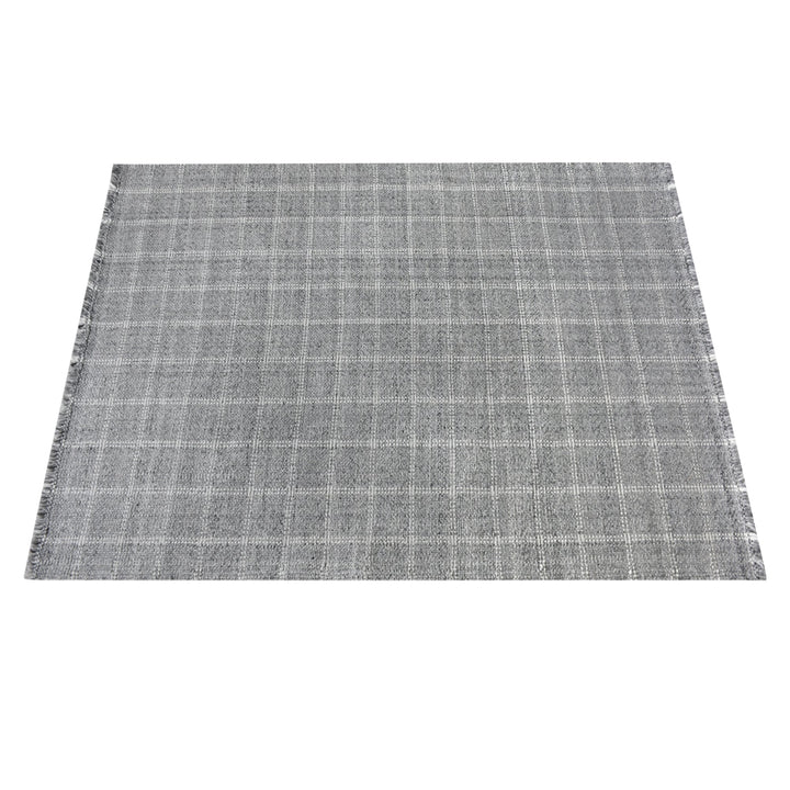 Pavilion handwoven slate grey and ivory recycled PET rug with a window-pane check, on a patio
