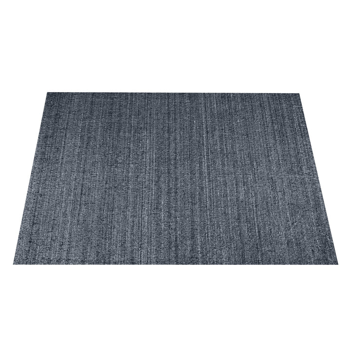 Saada handwoven flat wool rug in solid stone beige with charcoal, in a living room