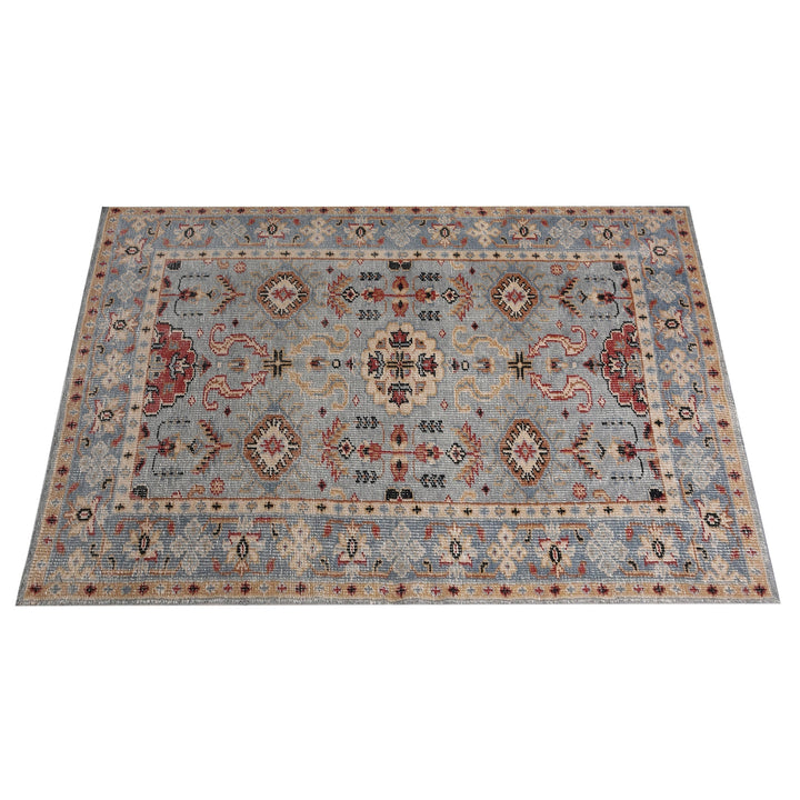 Manor hand-knotted slate grey wool rug with rust and red medallions, in a dining room