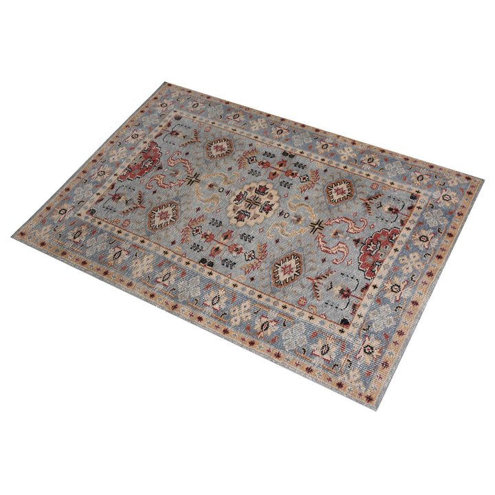 Manor hand-knotted slate grey wool rug with rust and red medallions, in a dining room