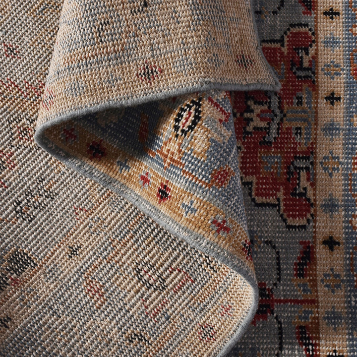 Manor hand-knotted slate grey wool rug with rust and red medallions, in a dining room