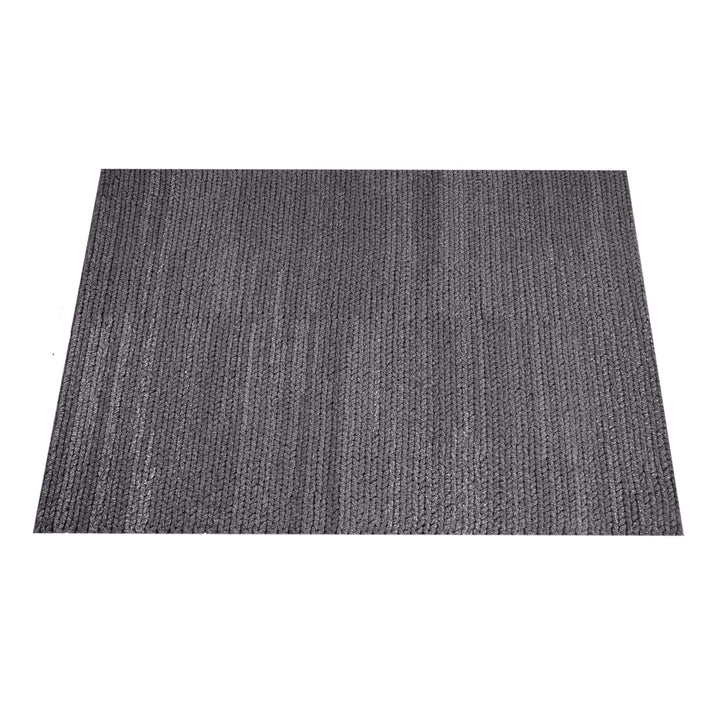 Dor handwoven chunky wool rug in charcoal, woven in thick cords, in a living room