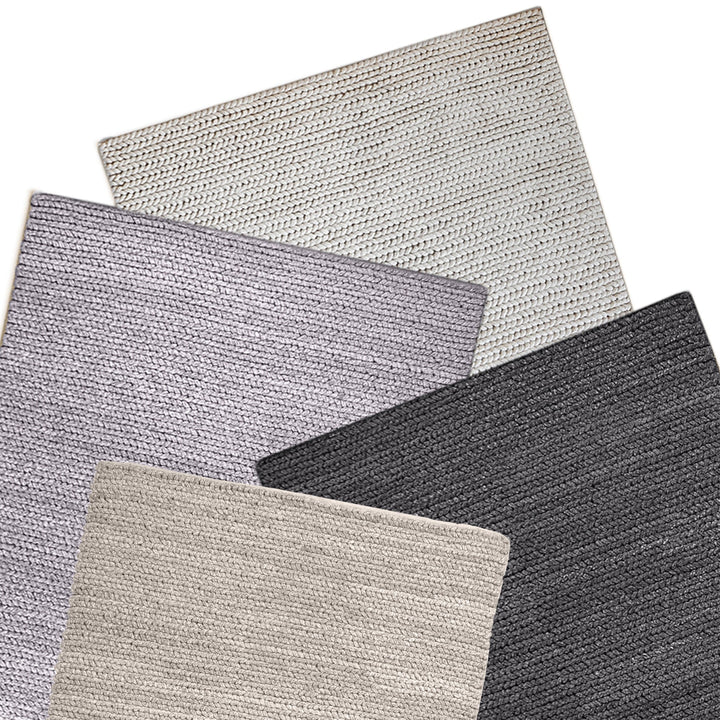 Dor handwoven chunky wool rug in charcoal, woven in thick cords, in a living room
