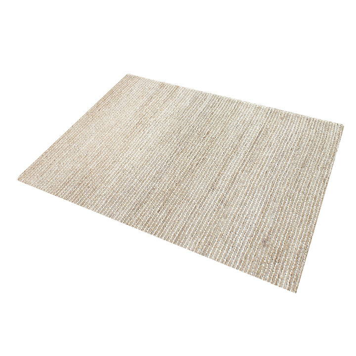 Kai handwoven hemp rug in natural with a sage cast and a tight chunky weave, in a living room