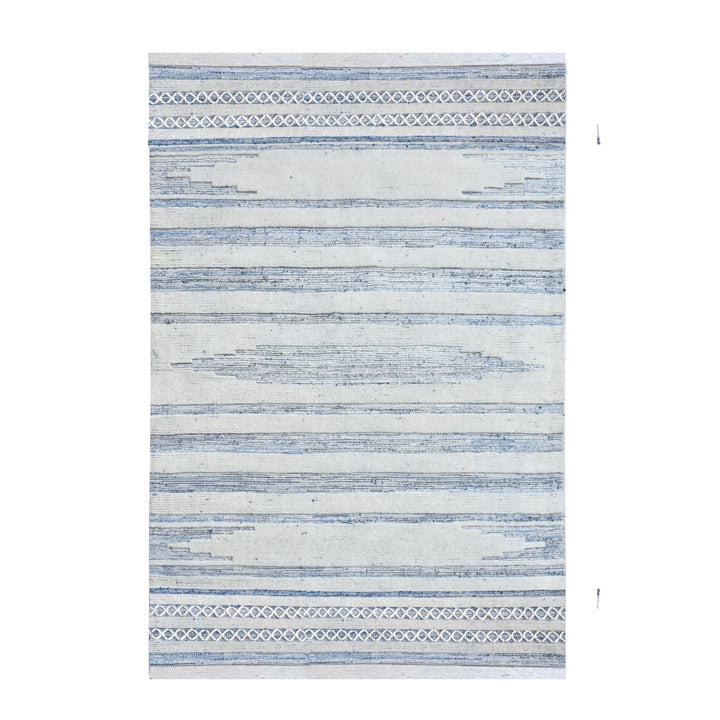 Breton handwoven denim and wool rug with blue and cream horizontal stripes, in a home office