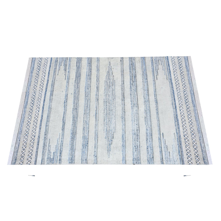 Breton handwoven denim and wool rug with blue and cream horizontal stripes, in a home office