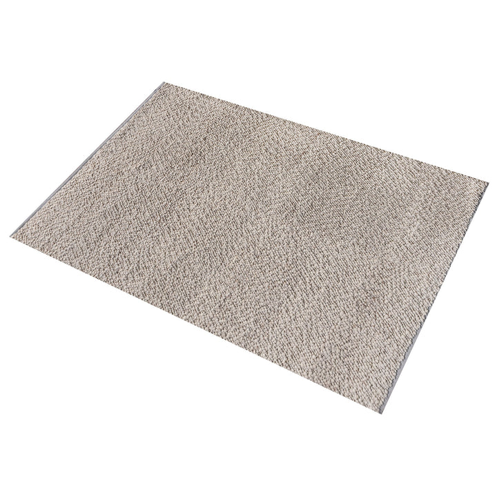 Mitti handwoven wool rug with a nubby looped weave in warm beige and brown, in a living room