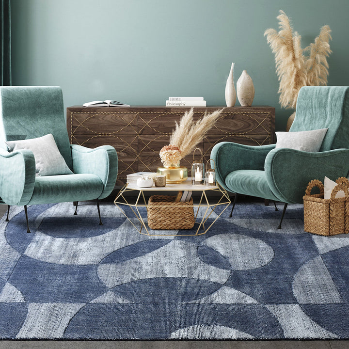 Mauj handwoven viscose and PET rug with denim blue overlapping circles on grey, in a living room
