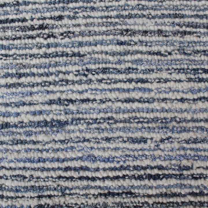 Estuary handwoven wool and denim rug with denim blue contour lines on ivory, in a dining room