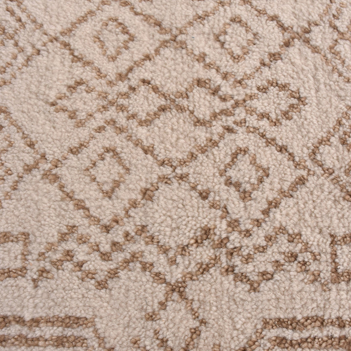 Gulab hand-knotted NZ wool rug with a blush medallion on an ivory field, in a bedroom