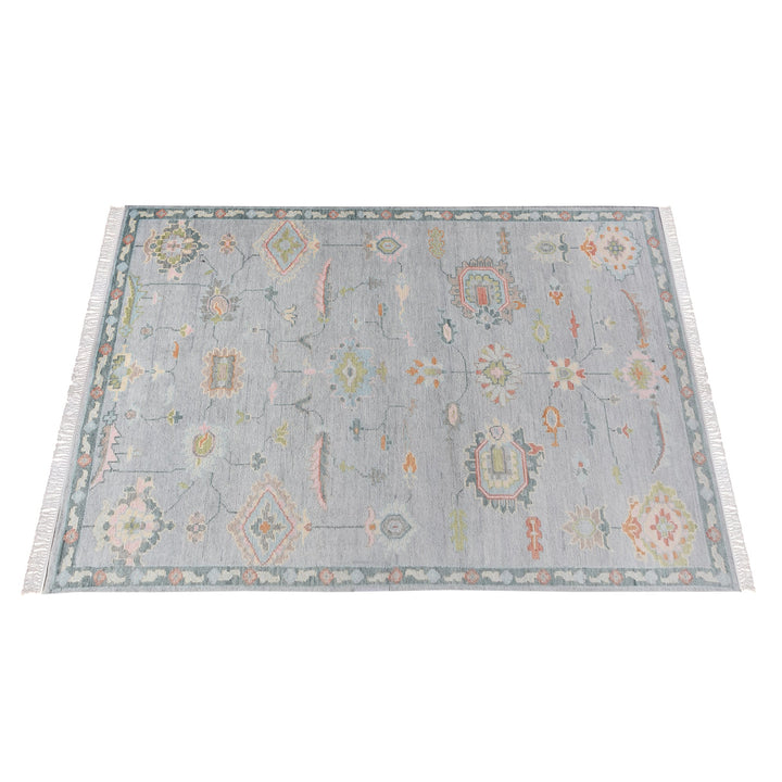Purana hand-knotted wool rug with faded Oushak florals in slate blue-grey, rose, sage and gold