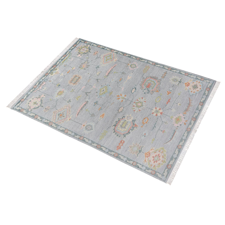Purana hand-knotted wool rug with faded Oushak florals in slate blue-grey, rose, sage and gold
