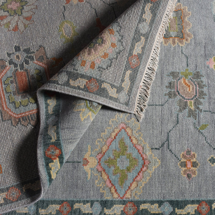 Purana hand-knotted wool rug with faded Oushak florals in slate blue-grey, rose, sage and gold