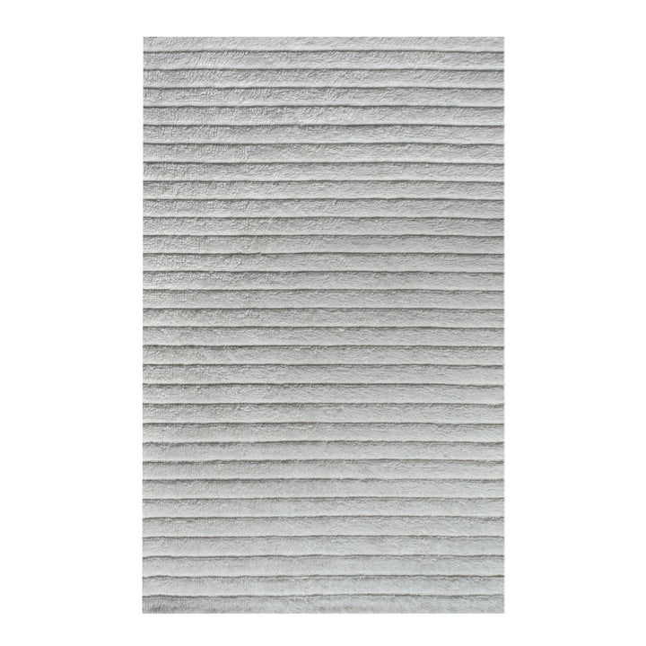 Sopan handwoven New Zealand wool rug with broad ivory ridges, in a living room
