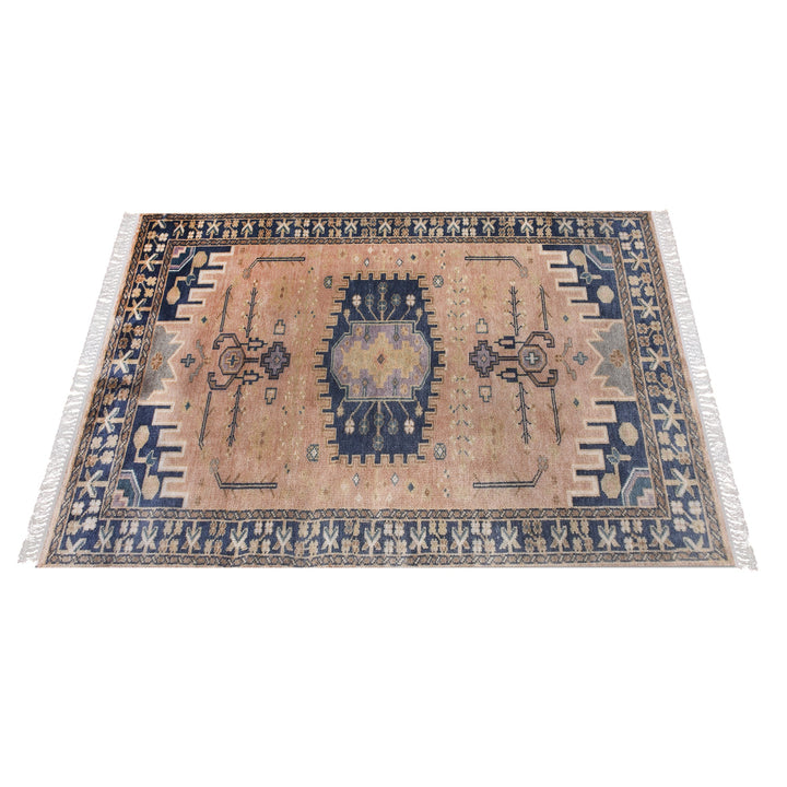 Darbar hand-knotted wool rug with rust and navy Anatolian medallions, in a living room