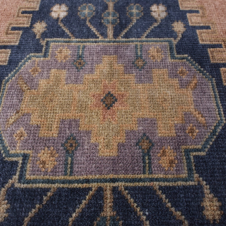 Darbar hand-knotted wool rug with rust and navy Anatolian medallions, in a living room