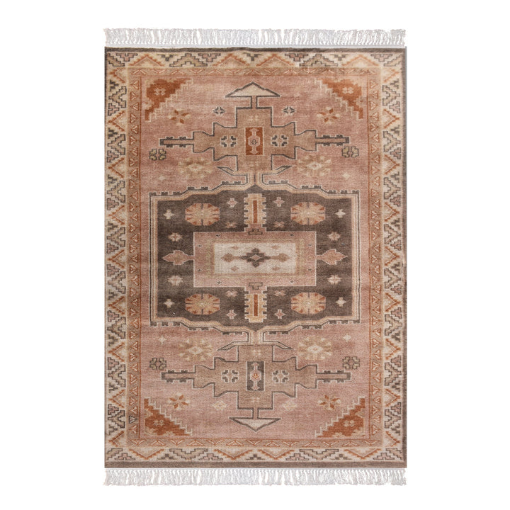 Matka hand-knotted wool rug with a faded terracotta Persian medallion, navy and brown, in a bedroom