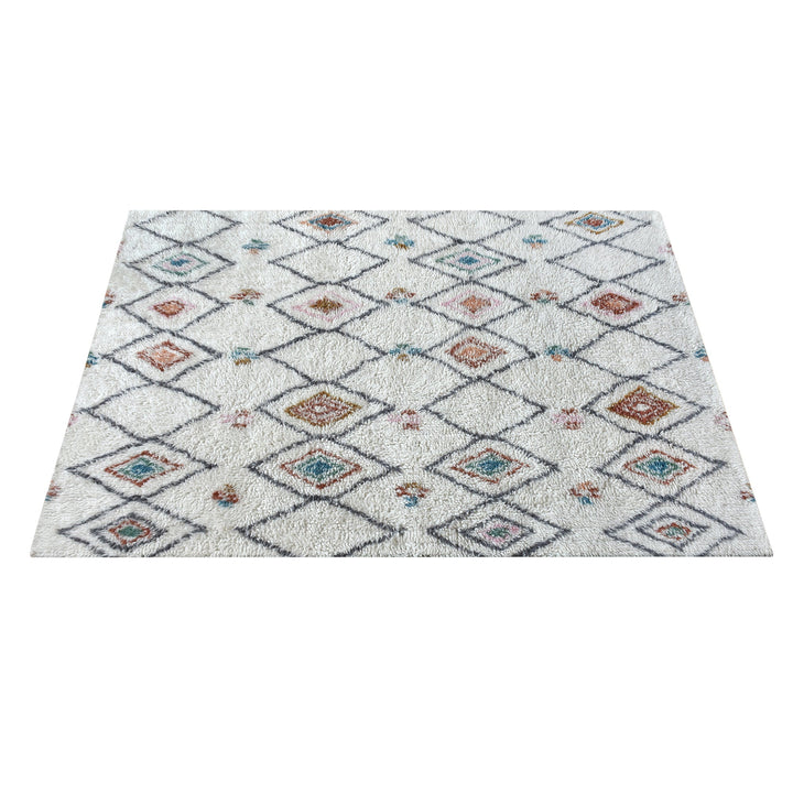 Mela tufted New Zealand wool rug with an ivory lattice and rust, teal and charcoal diamonds