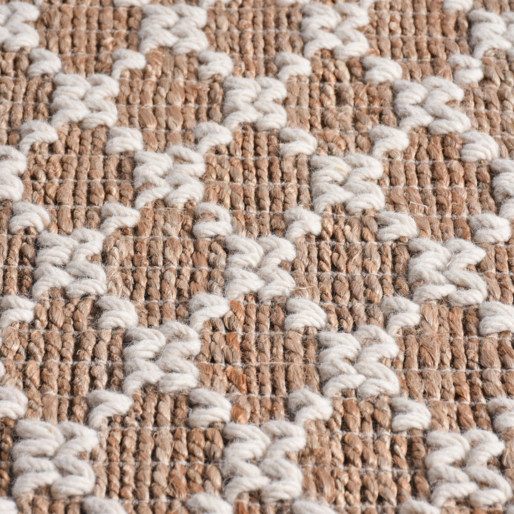 Lattice handwoven jute and wool rug with tan and ivory trellis pattern, in a dining room