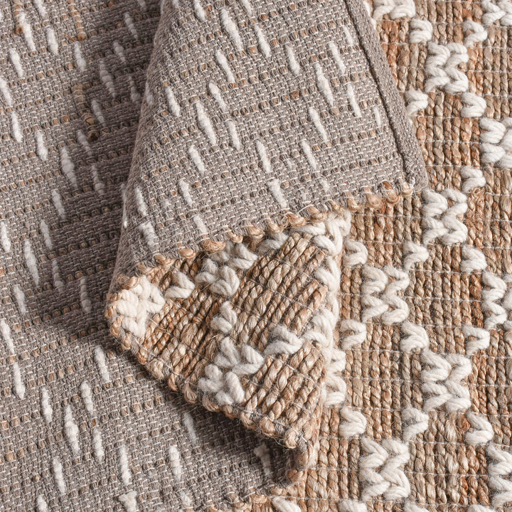 Lattice handwoven jute and wool rug with tan and ivory trellis pattern, in a dining room