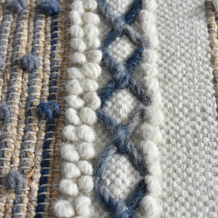 Bunting handwoven hemp and wool rug with horizontal rust, charcoal and ivory stripes, in a study