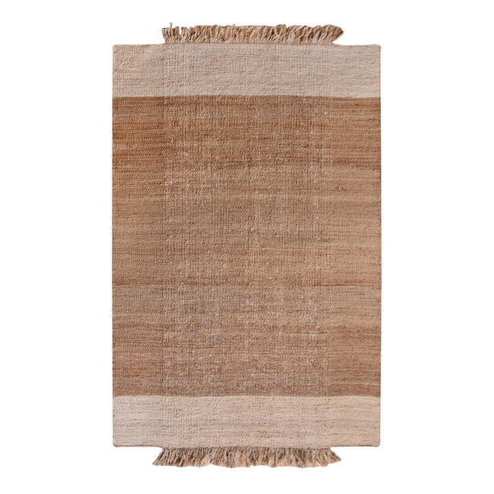 Sunbaked flatweave jute and wool rug in terracotta and blush colour blocks, in a living room