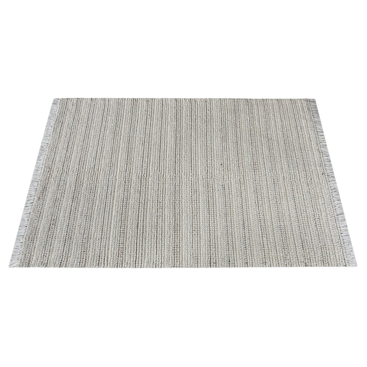 Kinara handwoven wool and jute rug in ivory and beige stripes, in a living room