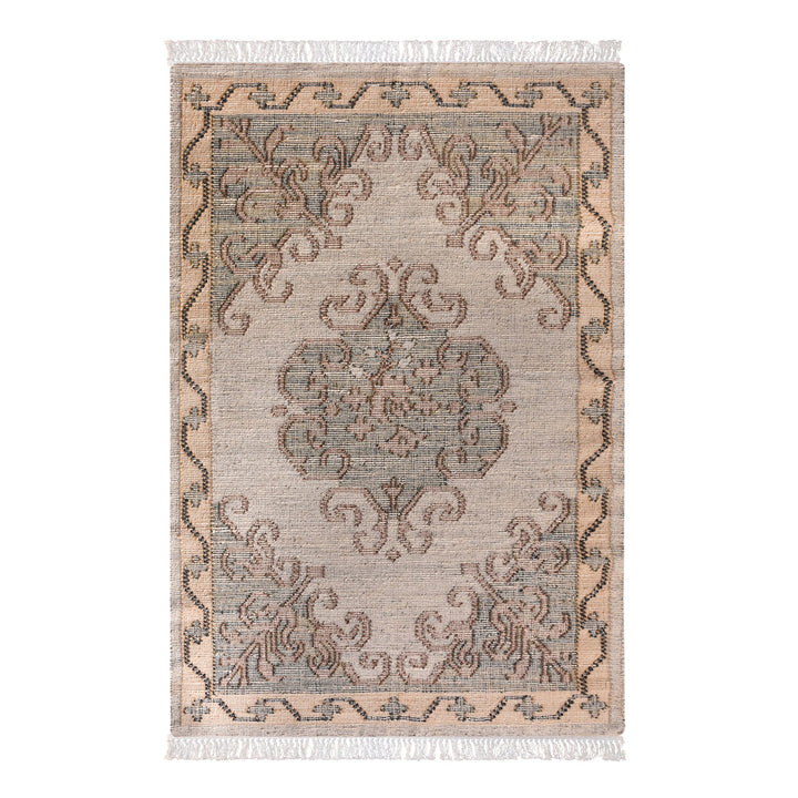 Haveli handwoven flatweave jute and wool rug with a faded beige medallion and terracotta border, in a living room