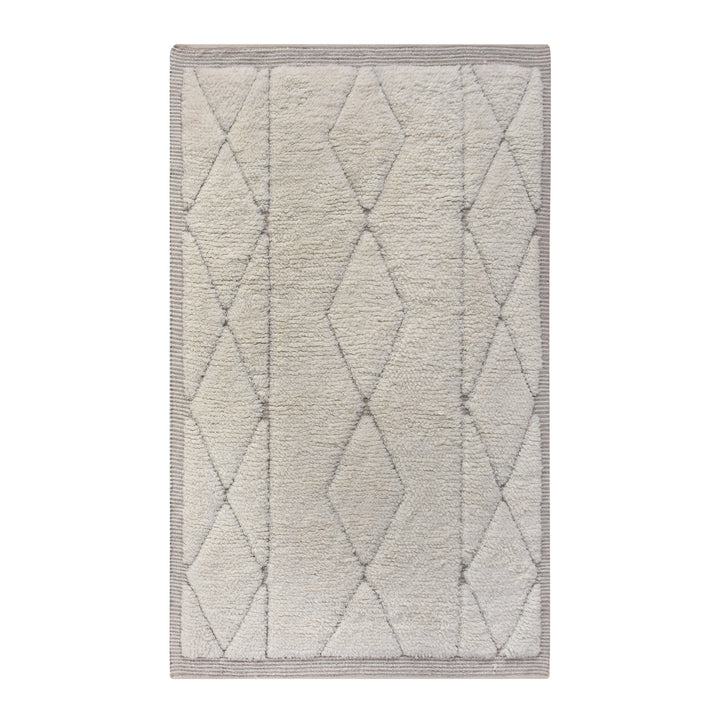 Ola handwoven New Zealand wool rug with an ivory Moroccan diamond lattice and grey, in a living room