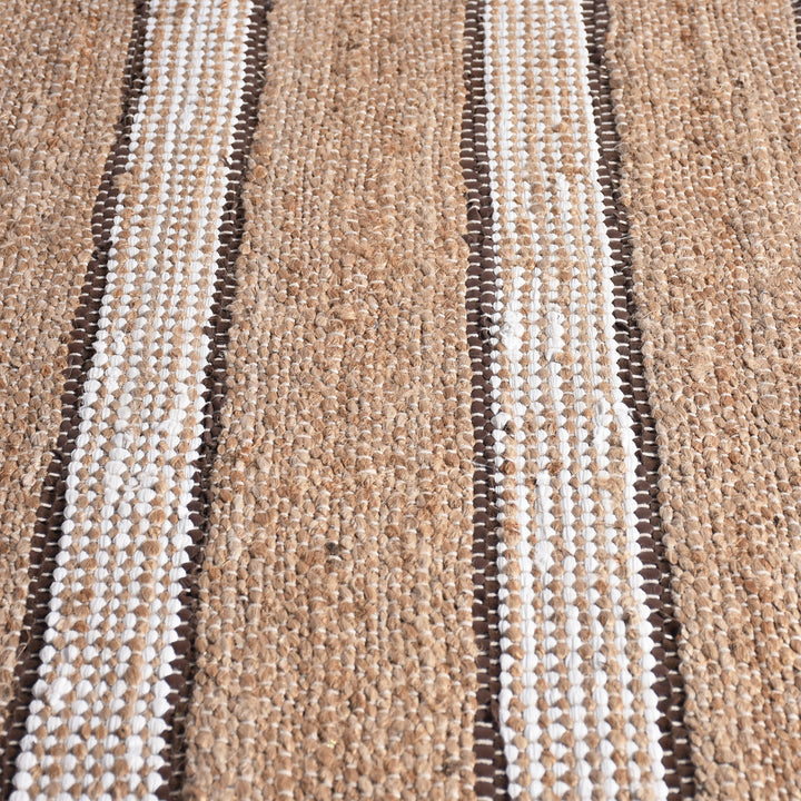 Hessian handwoven hemp and leather rug with ivory stripes on tan, in a dining room