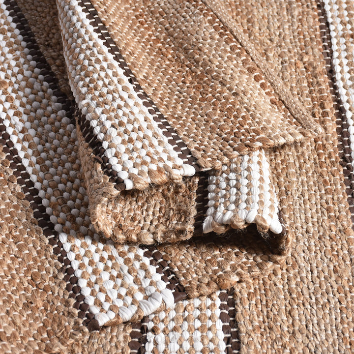 Hessian handwoven hemp and leather rug with ivory stripes on tan, in a dining room