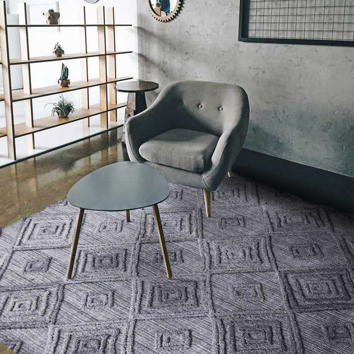 Jaali handwoven oatmeal wool rug with raised ivory diamond lattice, in a living room
