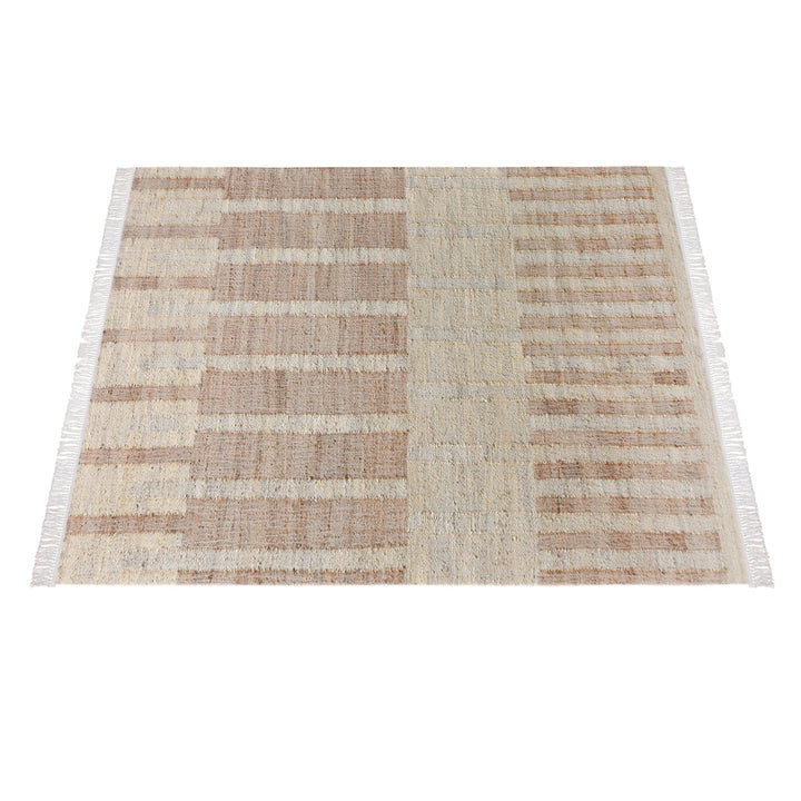 Diwar handwoven jute flatweave rug in natural, blush and ivory blocks, in a living room