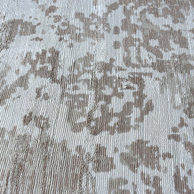 Parchhai handwoven viscose rug with an erased medallion on pale silver beige, in a living room