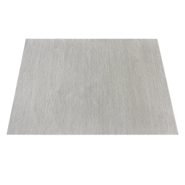 Mist handwoven pale stone wool rug with a chunky looped weave, in a living room