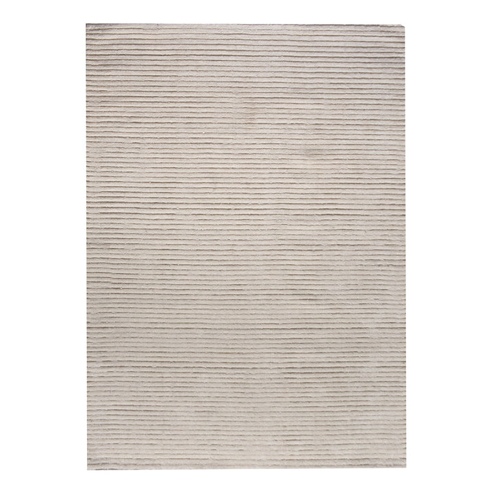 Hal handwoven NZ wool rug in ivory with wide ribbed stripes, in a dining room