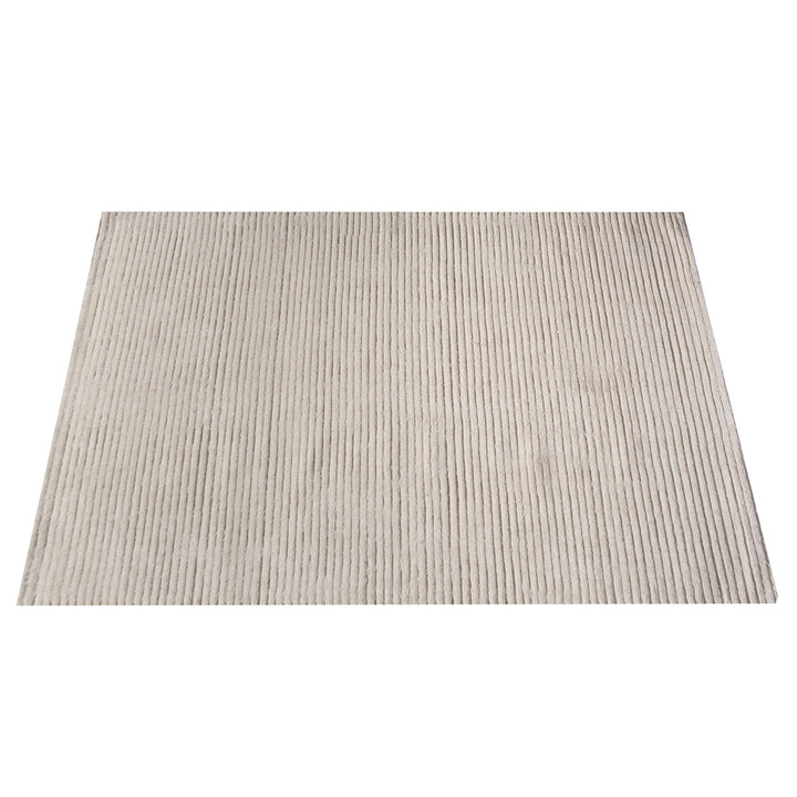 Hal handwoven NZ wool rug in ivory with wide ribbed stripes, in a dining room