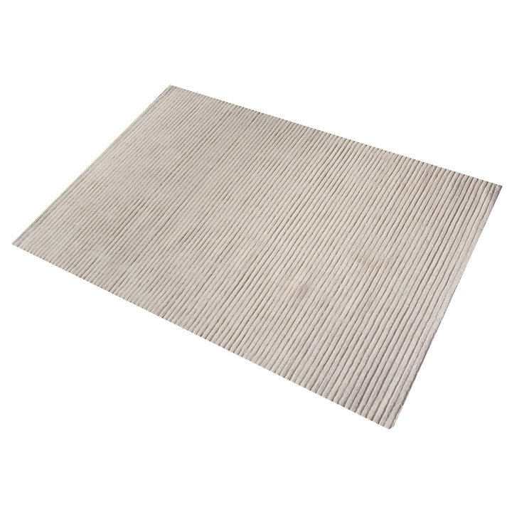 Hal handwoven NZ wool rug in ivory with wide ribbed stripes, in a dining room