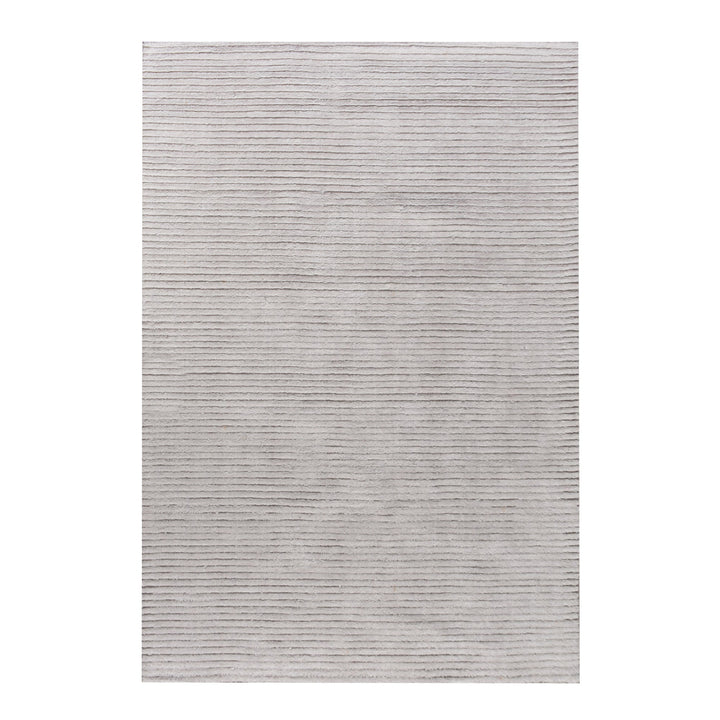 Megh handwoven NZ wool rug in light grey with wide ribbed vertical bands, in a living room