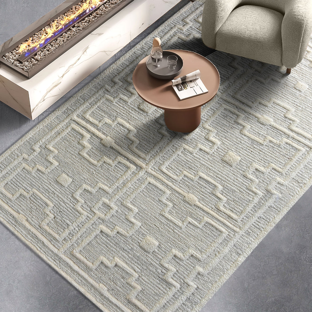 Chattan handwoven New Zealand wool rug with raised ivory diamonds on stone grey, in a living room