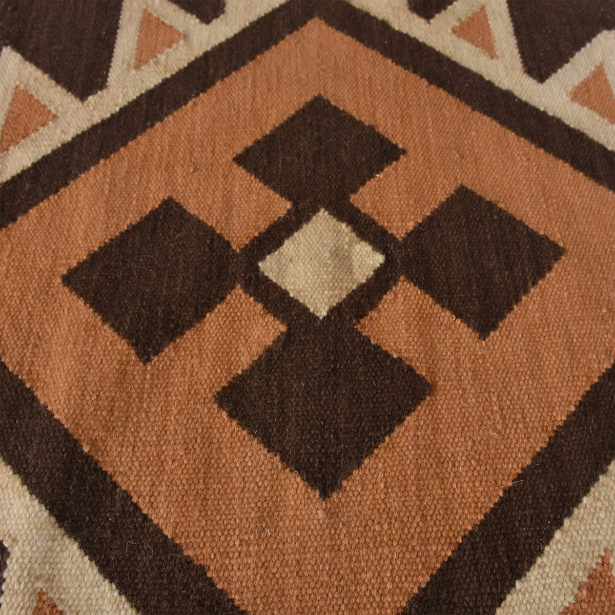 Ember flatweave New Zealand wool rug with rust and cream Southwestern diamonds, in an entryway