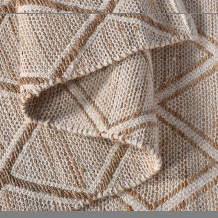 Chik handwoven wool and jute rug with a carved diamond lattice in ivory and natural, in a living room