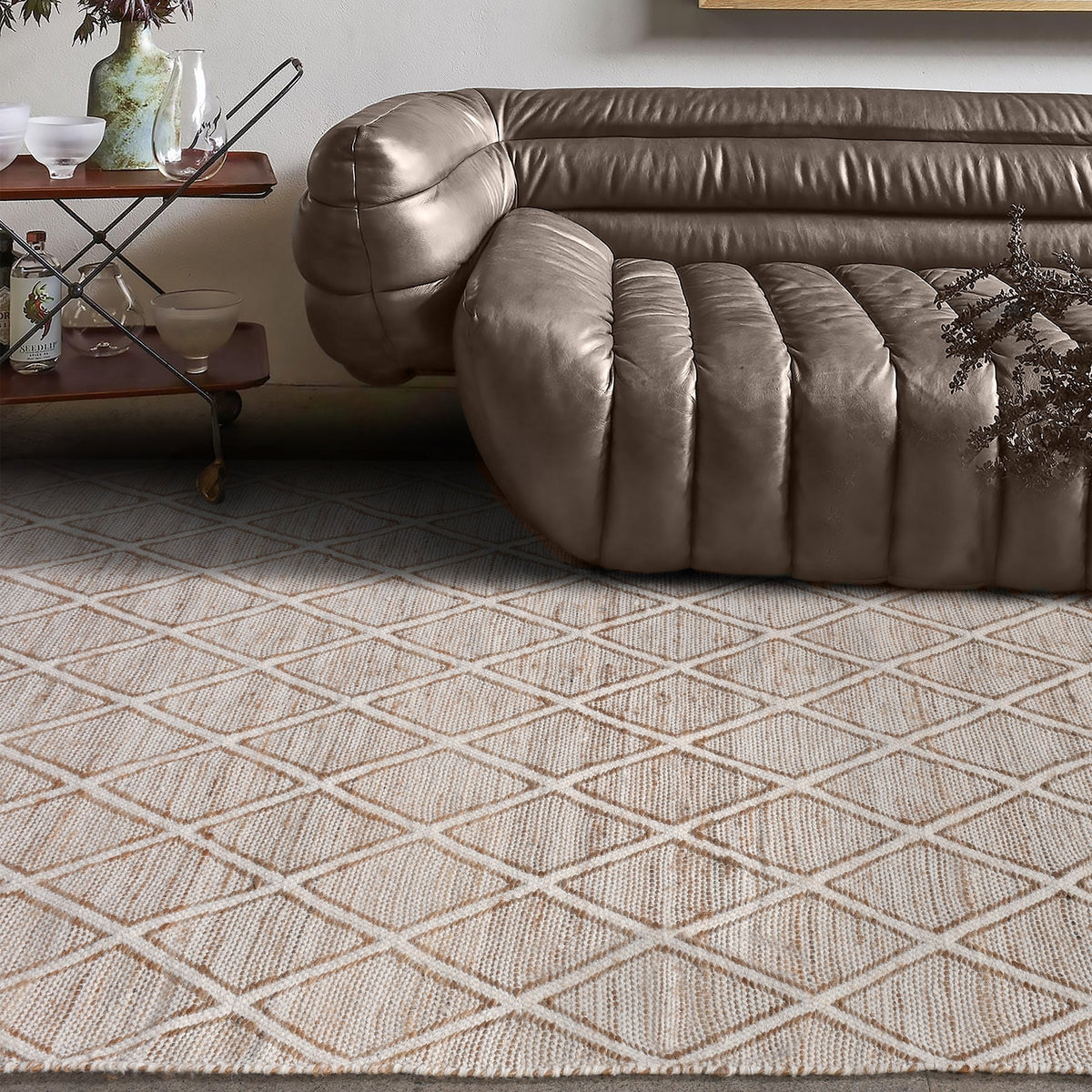 Chik handwoven wool and jute rug with a carved diamond lattice in ivory and natural, in a living room