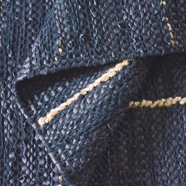 Aasmaan handwoven hemp and leather rug with cream nested angles on midnight navy, in a study