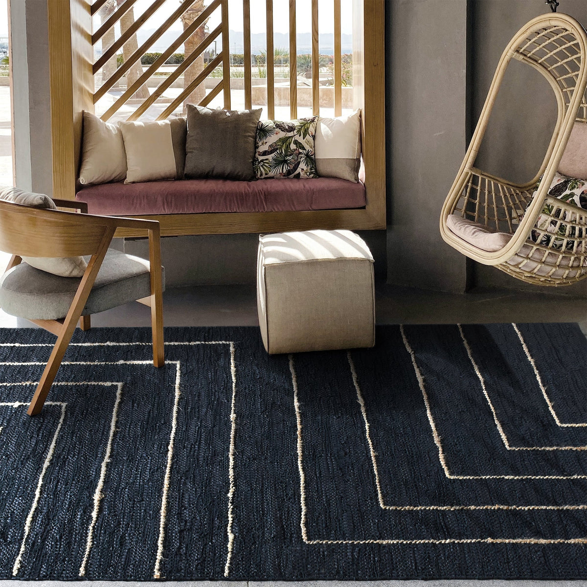 Aasmaan handwoven hemp and leather rug with cream nested angles on midnight navy, in a study